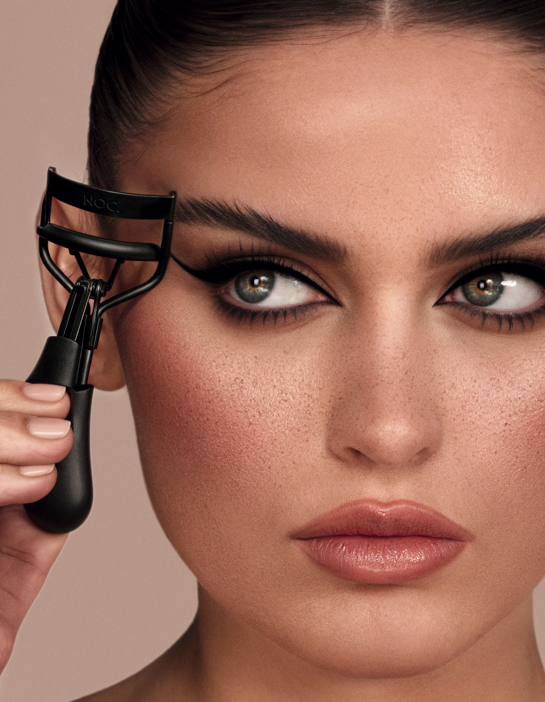 Frau verwendet NOC Wimpernzange für perfekt geschwungene Wimpern – sanfte Anwendung am Wimpernansatz